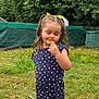 child, girl, flower, dandelion, grass, outdoor, nature, greenery, summer, cute, smiling, hair, pigtails, blue_clothing, patterned_clothing, playful, young, garden, peaceful, portrait