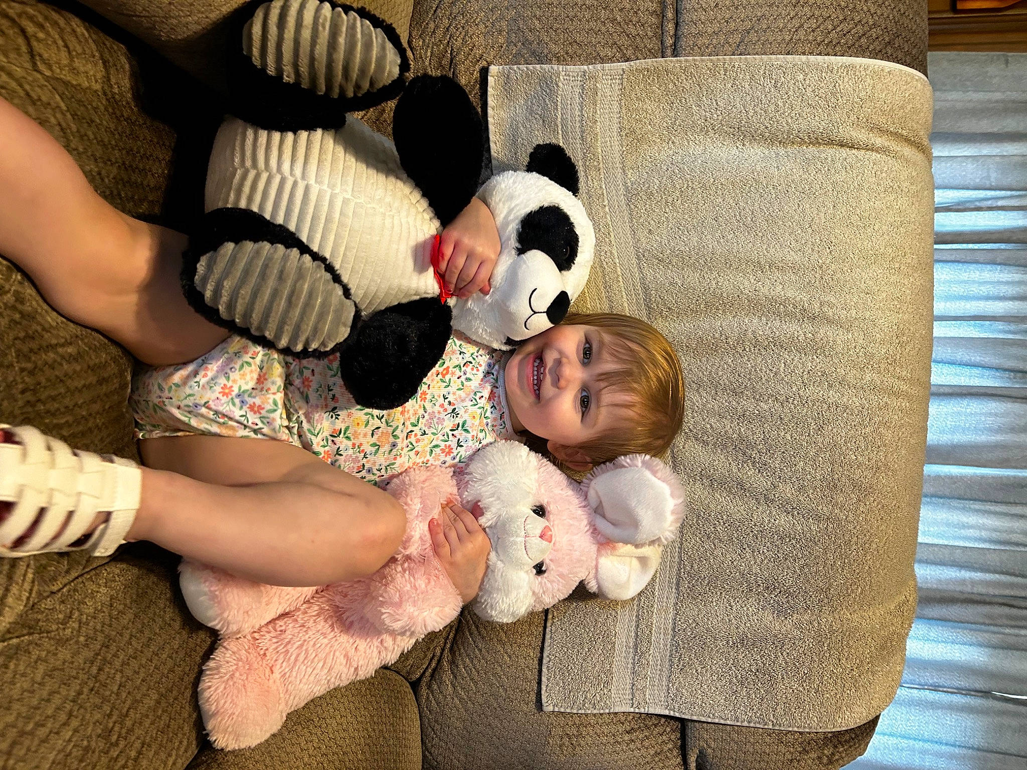 Legacy is registered to the contest to win money with this photo: baby, baby_toddler_clothing, child, comfort, couch, foot, fun, fur, gesture, happy, head, human_body, human_leg, joy, person, sitting, stuffed_toy, textile, thigh, thumb