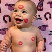 Weston joined the competition — help win amazing prizes! baby, child, smiling, lipstick_marks, face, skin, arms, torso, blanket, pink_background, patterned_blanket, happy, cute, infant, seated, expression, playful, red, lips, portrait