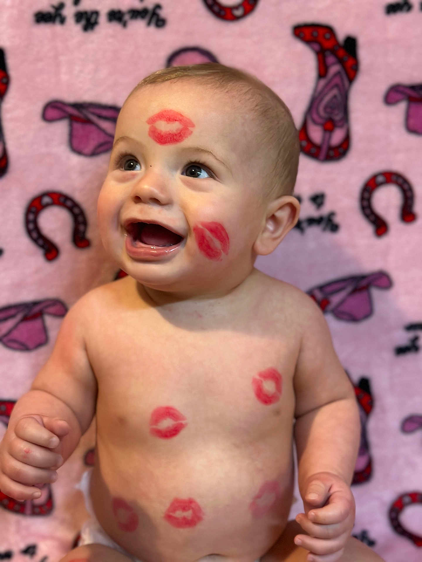 Weston joined the competition — help win amazing prizes! baby, child, smiling, lipstick_marks, face, skin, arms, torso, blanket, pink_background, patterned_blanket, happy, cute, infant, seated, expression, playful, red, lips, portrait