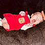 Nathania is registered to the contest to win money with this photo: baby, infant, yawning, red_outfit, headband, bow, white_socks, cute, sleepy, lying_down, fuzzy_blanket, soft_texture, small_hands, adorable, child, newborn, portrait, cozy, indoors, sleepwear