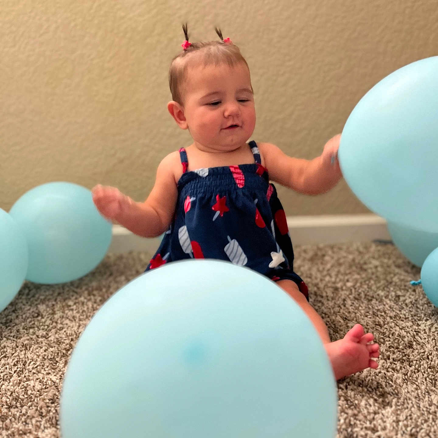 Nathania joined the competition — help win amazing prizes! baby, balloon, blue, carpet, celebration, child, cute, dress, foot, fun, happy, indoor, infant, person, pigtails, playful, room, sitting, small_person, wall