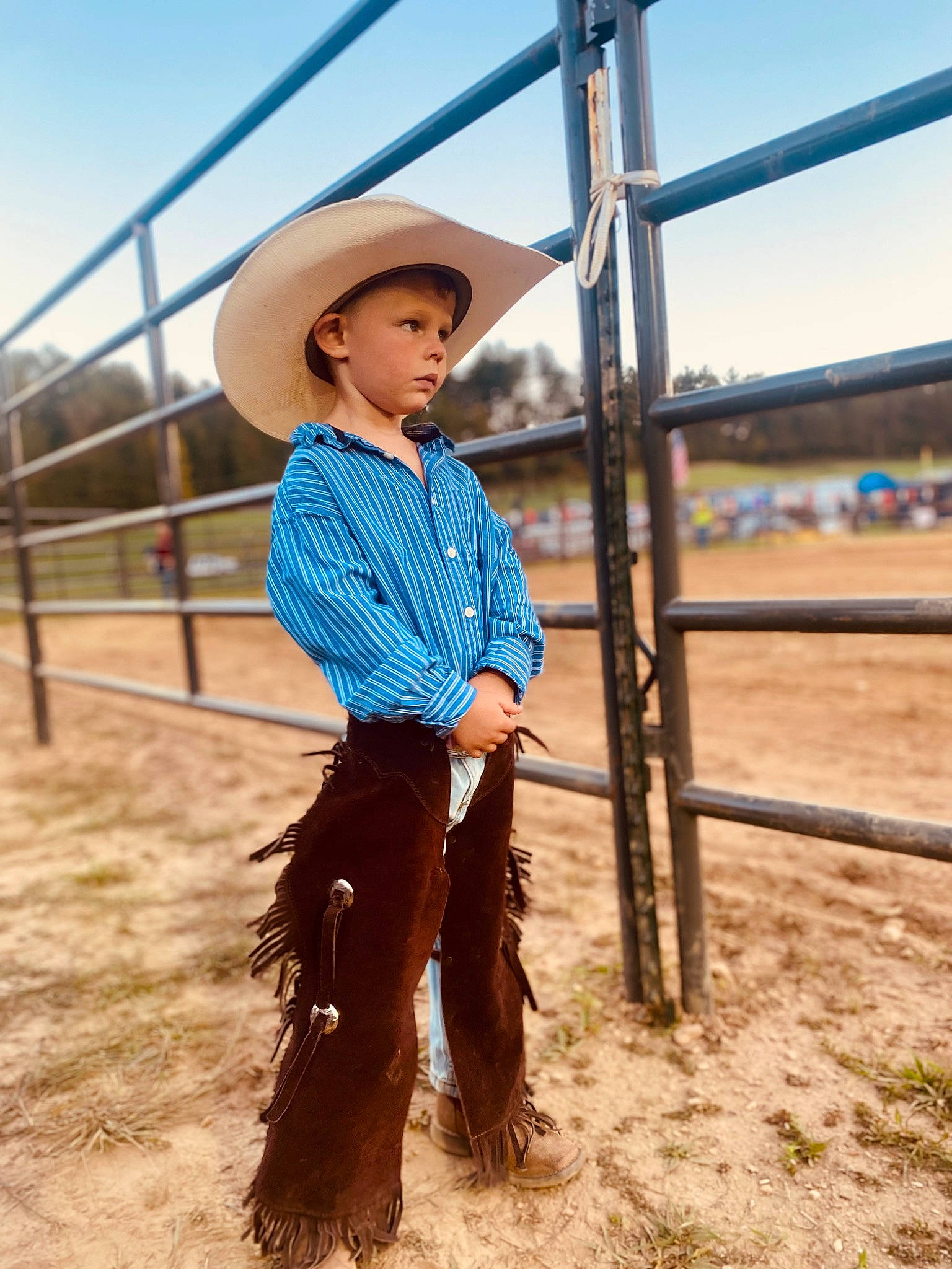 Jackson James is registered to the contest to win money with this photo: agriculture, cool, cowboy_hat, electric_blue, fashion_design, fence, fun, happy, hat, headgear, headwear, landscape, mammal, people_in_nature, person, rural_area, sand, sky, standing, sun_hat