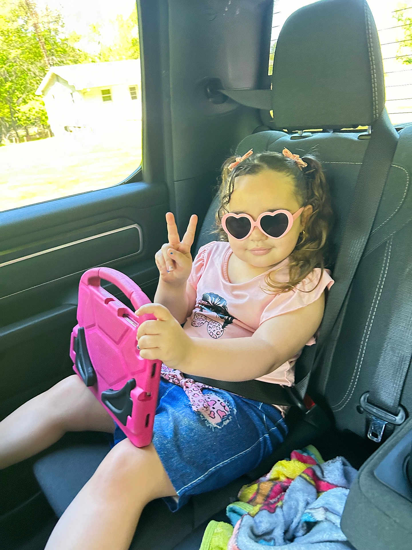 Ediatny joined the competition — help win amazing prizes! child, girl, sunglasses, heart_shaped, tablet, car_seat, seatbelt, pink, peace_sign, clothing, denim_skirt, hair_bows, window, blanket, interior, vehicle, summer, casual, playful, happy