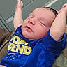 Oakley joined the competition — help win amazing prizes! baby, infant, sleeping, blue_shirt, arms_up, close_up, peaceful, indoors, person, child, newborn, cute, face, portrait, relaxed, resting, clothing, skin, young, expression
