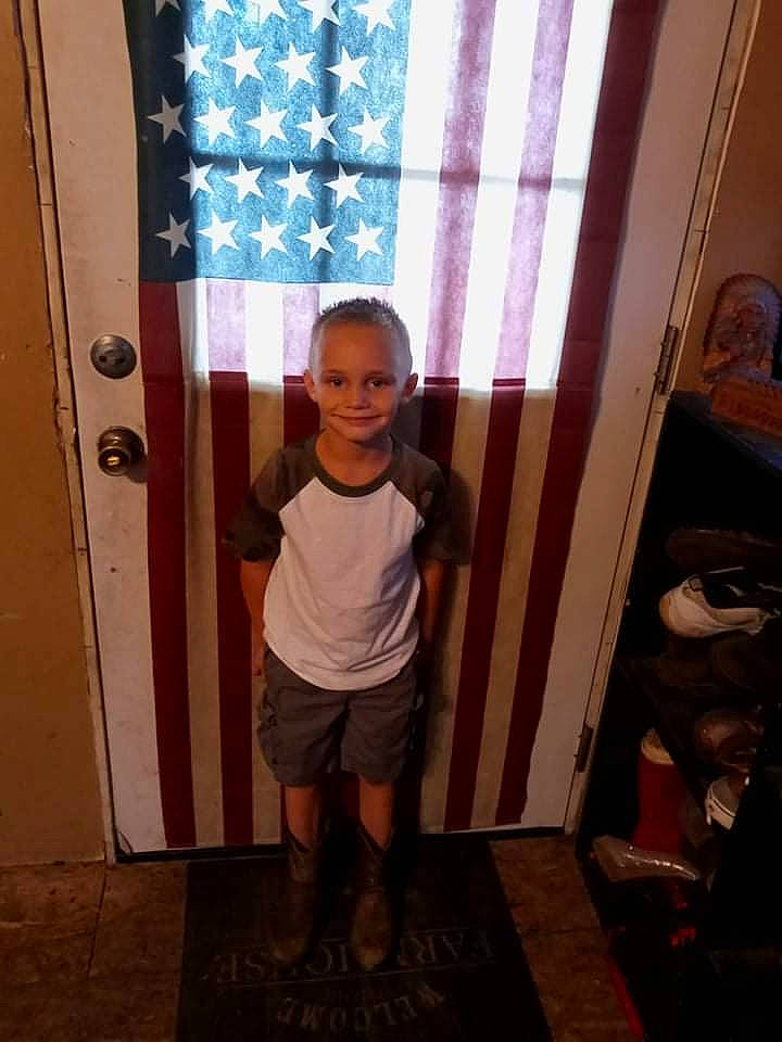 Bentley is registered to the contest to win money with this photo: child, curtain, door, flooring, fun, happy, hat, home_door, human_leg, joy, magenta, pattern, person, room, shorts, sleeve, smile, standing, t_shirt, thigh