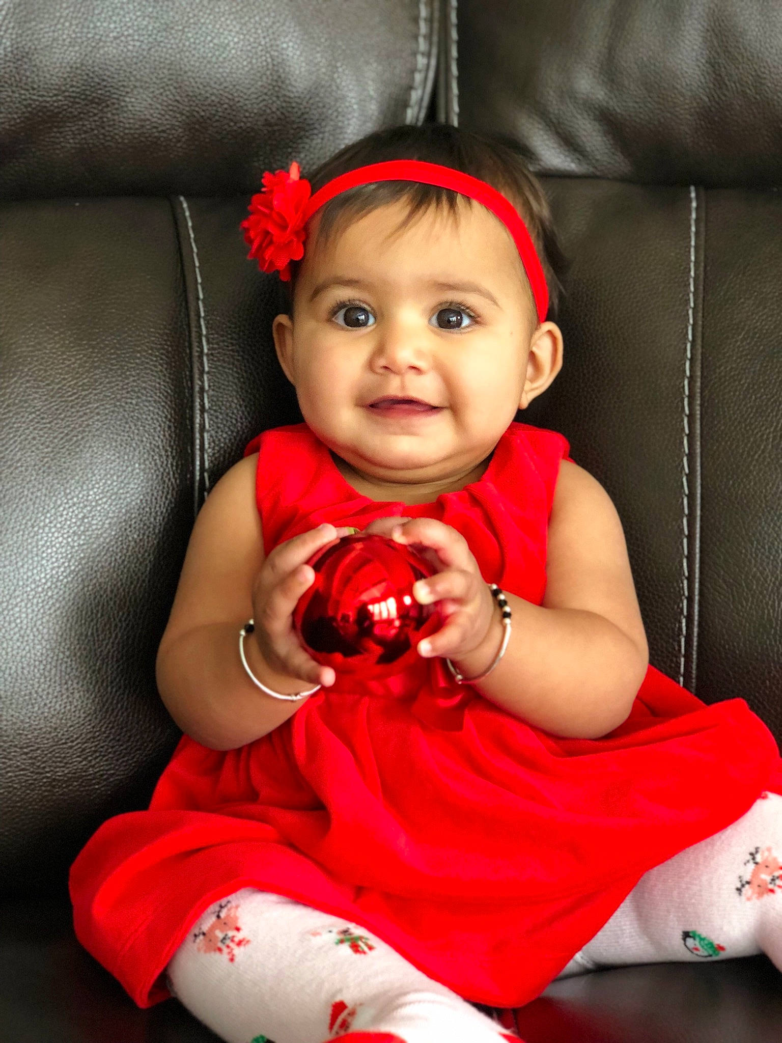 Aayra is registered to the contest to win money with this photo: arm, baby, cheek, child, child_model, finger, leg, lip, person, photo_shoot, portrait_photography, red, sitting, skin, smile, toddler