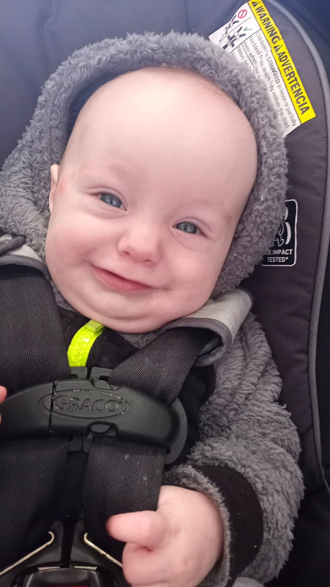 Tobias is registered to the contest to win money with this photo: baby, baby_carriage, baby_products, baby_safety, baby_toddler_clothing, cheek, child, close_up, comfort, cool, eye, finger, flash_photography, happy, iris, joy, nose, outerwear, person, skin