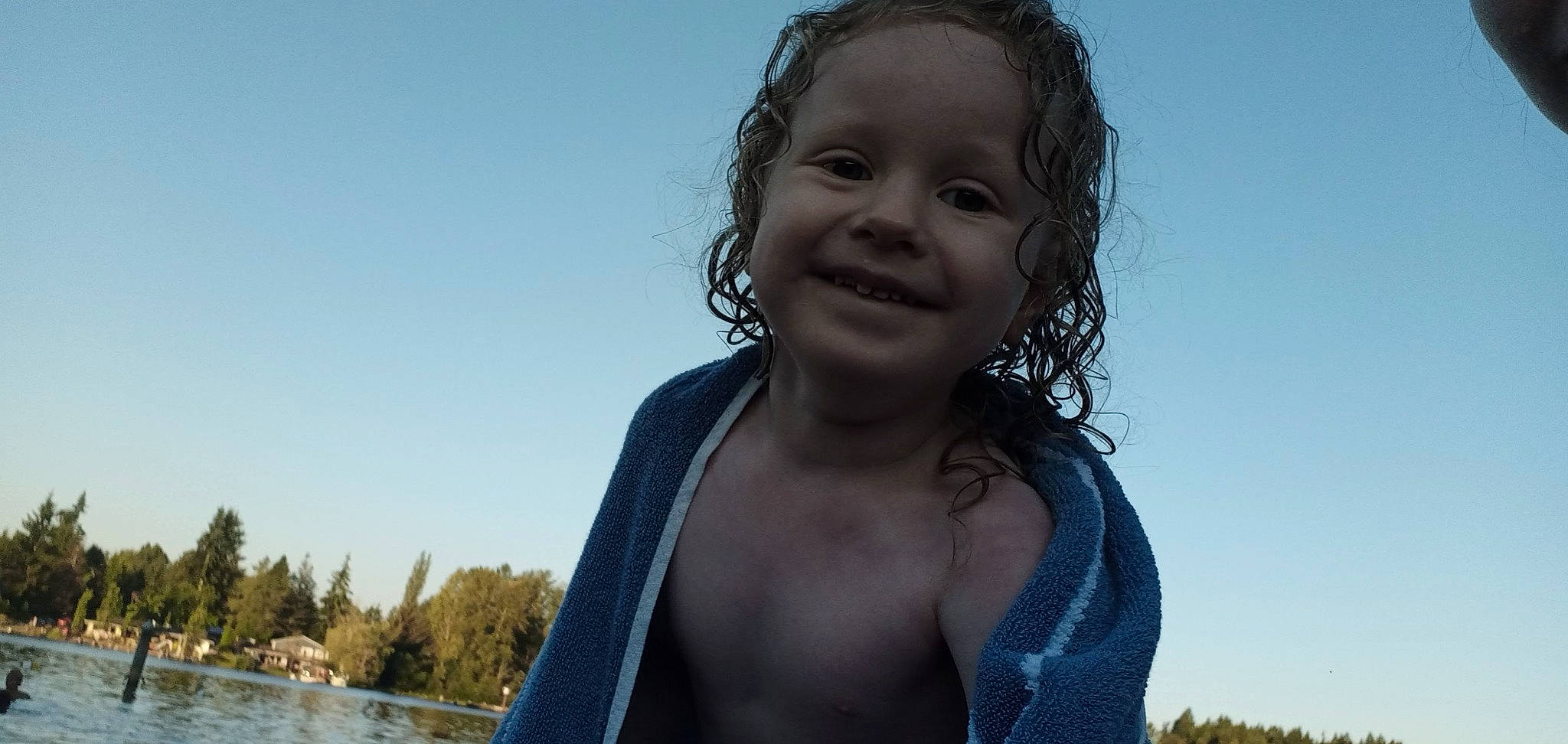 Moses is registered to the contest to win money with this photo: black_hair, chest, electric_blue, flash_photography, fun, grass, hair, happy, iris, joy, leisure, lip, long_hair, people_in_nature, person, portrait_photography, sky, smile, swimwear, toddler