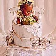 Nairobi Naiomi is registered to the contest to win money with this photo: baby, child, bucket, chair, lace, flower, vintage_clothing, bonnet, wooden_furniture, decor, homedecor, cute, smiling, indoor, portrait, sitting, white, fabric, cozy, rustic