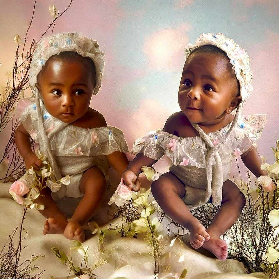 Nairobi Naiomi is registered to the contest to win money with this photo: baby, infant, child, lace, bonnet, flowers, pastel_background, cute, sitting, delicate, soft_lighting, nature, adorable, twins, portrait, smiling, holding_hands, young, outdoor_style, playful