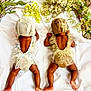 Nairobi Naiomi is registered to the contest to win money with this photo: baby, infant, back_view, lying_down, floral_outfit, knitted_bonnet, white_sheet, greenery, yellow_flowers, wreath, cute, toddler, skin, legs, arms, soft_lighting, decor, nature, resting, sleeping_position