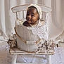 Nairobi Naiomi joined the competition — help win amazing prizes! baby, infant, child, bucket, wooden_chair, lace, bonnet, flowers, white, decor, portrait, cute, smiling, indoors, soft_lighting, vintage_style, fabric, floor_rug, face, person