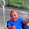 baby, blue_shirt, casual_clothing, child, cute, daytime, fence, fun, greenery, happy, infant, joyful, metal_chain, outdoor, park, person, playground, seat, smiling, swing