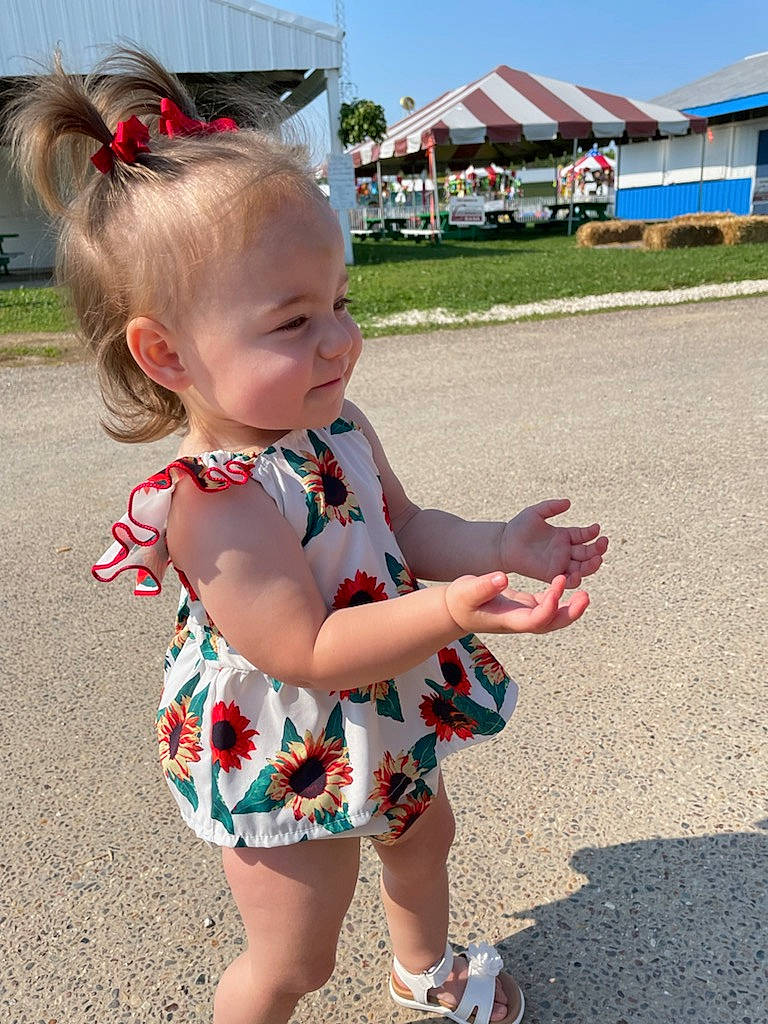 Molly is registered to the contest to win money with this photo: baby, baby_toddler_clothing, blue, dress, eye, fun, grass, hair, happy, head, leaf, leisure, person, pink, plant, skin, sky, summer, toddler, tree