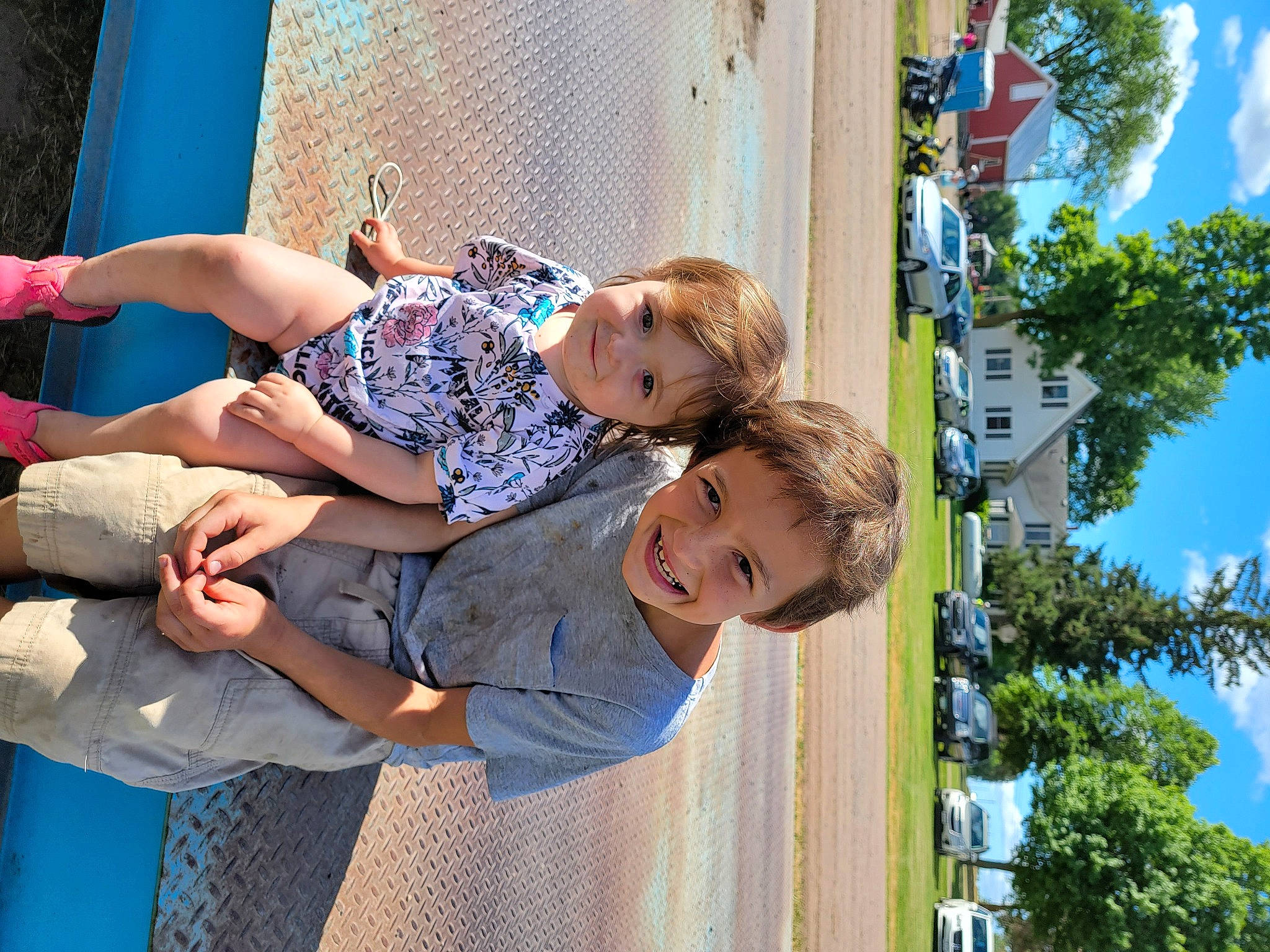 Raylynn joined the competition — help win amazing prizes! azure, blue, child, city, cloud, electric_blue, event, eyewear, fun, happy, house, joy, leisure, person, play, public_space, recreation, shorts, sitting, sky