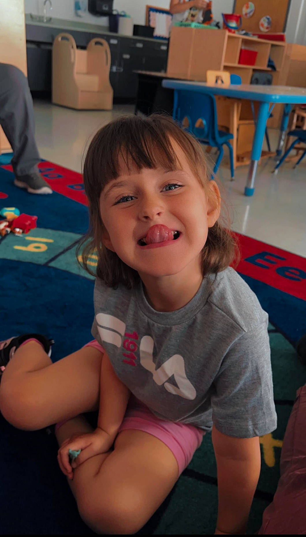 Kinslee Rae is registered to the contest to win money with this photo: chair, cheek, chin, facial_expression, finger, floor, flooring, fun, hairstyle, happy, human, iris, joint, joy, leisure, mouth, person, shoulder, skin, smile
