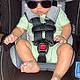 baby, sunglasses, car_seat, child, infant, safety_harness, cute, clothing, foot, hand, seat, indoor, person, toddler, head, eyewear, resting, infant_clothing, baby_seat, strap