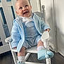 Hunter joined the competition — help win amazing prizes! baby, child, smiling, blue_clothing, knitwear, rocking_chair, white_furniture, nursery, crib, happy, indoor, footwear, socks, person, portrait, cute, infant, seated, flooring, light