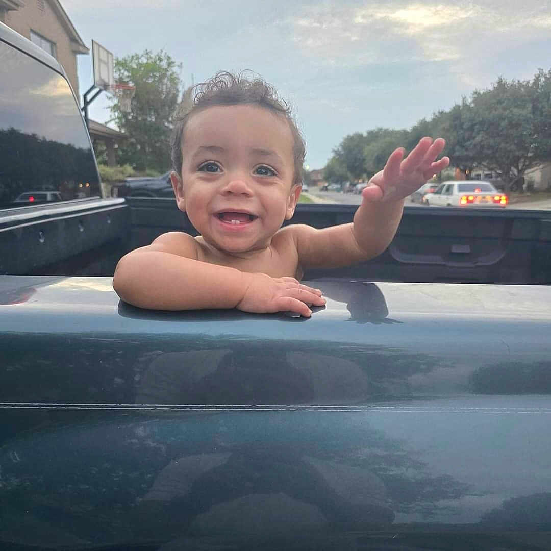 Ellis is registered to the contest to win money with this photo: baby, bodypart, car, city, face, finger, hand, happy, head, outdoors, person, photography, portrait, road, sitting, smile, street, transportation, urban, vehicle