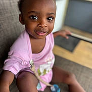 Amory joined the competition — help win amazing prizes! toddler, child, face, eyes, pink_shirt, pacifier, sitting, couch, indoor, expression, skin, hair, cute, person, portrait, clothing, furniture, blurred_background, happy, young_child