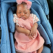 Jasmine is registered to the contest to win money with this photo: baby, sleeping, infant, pink, headband, car_seat, clothing, cute, child, young, hands, footwear, fabric, comfort, resting, adorable, portrait, seat, transport, peaceful