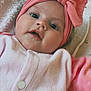 baby, infant, pink_headband, bow, blanket, cozy, soft_clothing, face, close_up, cute, child, lying_down, indoors, cherry_pattern, apparel, headwear, newborn, person, portrait, baby_girl