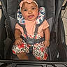 baby, child, stroller, headband, pink, floral, clothing, smiling, happy, infant, seatbelt, sitting, indoors, person, cute, face, portrait, toddler, fabric, comfort
