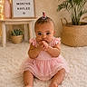 baby, infant, girl, pink_dress, sitting, carpet, indoor, plant, milestone, sign, decor, cute, portrait, child, young, expression, hands, hair_clip, floor, home