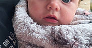 Isabella is registered to the contest to win money with this photo: baby, infant, child, portrait, face, wide_eyes, blue_eyes, blond_hair, fluffy_blanket, blanket, wrapped, sitting, close_up, outdoor, window, adult, shirt, cuddling, curious, adorable