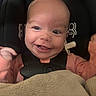 baby, infant, smile, face, car_seat, blanket, pacifier, clothing, child, happy, cute, person, seatbelt, indoors, closeup, head, expression, baby_girl, baby_boy, adorable