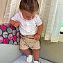 Harsëne participe au concours pour gagner de l'argent avec cette photo : toddler, child, white_polo_shirt, shorts, white_shoes, hair, curtain, cushion, pattern, indoor, standing, looking_down, clothing, footwear, furniture, person, cute, young_child, colorful_cushion, window