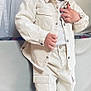 Harsëne participe au concours pour gagner de l'argent avec cette photo : toddler, child, standing, white_clothing, jacket, pants, shoes, indoors, couch, curtains, portrait, casual, fashion, young_child, person, cute, expression, hair, buttoned_jacket, footwear