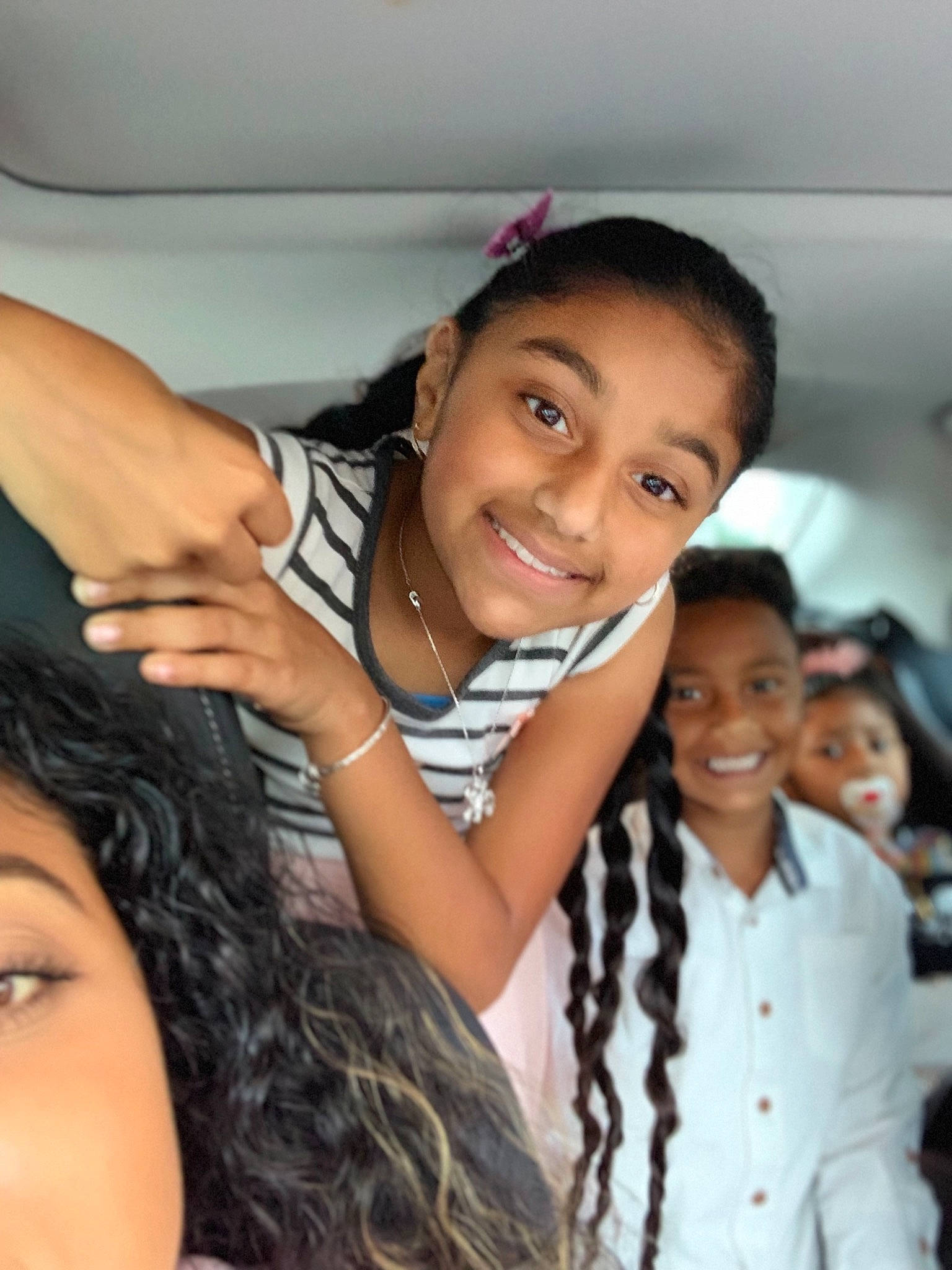 Chloe is registered to the contest to win money with this photo: black_hair, child, eyebrow, forehead, friendship, fun, gesture, hair, hairstyle, happy, joy, long_hair, person, photography, selfie, skin, smile
