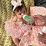 Rylee is registered to the contest to win money with this photo: baby, infant, bottle, feeding, pink_tutu, headband, bunny_ears, crocheted_blanket, hand, tissue, soft_texture, portrait, cute, newborn, lying_down, clothing, indoor, human, skin, sleepwear