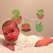 Thiago Solano is registered to the contest to win money with this photo: baby, infant, white_clothing, blanket, lying_down, face, head, skin, newborn, child, cute, indoors, celebration, decorations, number_two, months, soft_texture, resting, portrait, expression