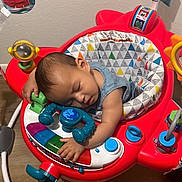 Tenyang joined the competition — help win amazing prizes! baby, infant, sleeping, nap, child, portrait, face, closed_eyes, activity_center, play_center, toys, colorful, red, indoor, home, nursery, wood_floor, seated, peaceful, candid