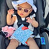 Tenyang is registered to the contest to win money with this photo: baby, child, infant, car_seat, sunglasses, sun_hat, outdoor, portrait, seated, harness, toy, stuffed_animal, pink, clothing, dress, safe, vehicle, travel, looking_at_camera, funny_pose