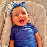 Liliana joined the competition — help win amazing prizes! baby, smiling, blue_headband, blue_shirt, baby_seat, cushion, happy, infant, person, portrait, cute, child, indoors, comfortable, face, headwear, clothing, skin, hand, relaxed