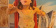Elina participe au concours pour gagner de l'argent avec cette photo : background, cape, child, colorful, cute, expression, fashion, fun, girl, indoor, pants, playful, posing, pretending, smiling, socks, standing, superhero, tank_top, young