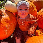 Davina joined the competition — help win amazing prizes! baby, pumpkin, orange, white_pumpkin, headband, smiling, outdoor, fall, autumn, child, cute, clothing, sock, sitting, nature, harvest, festive, sunlight, garden, happy