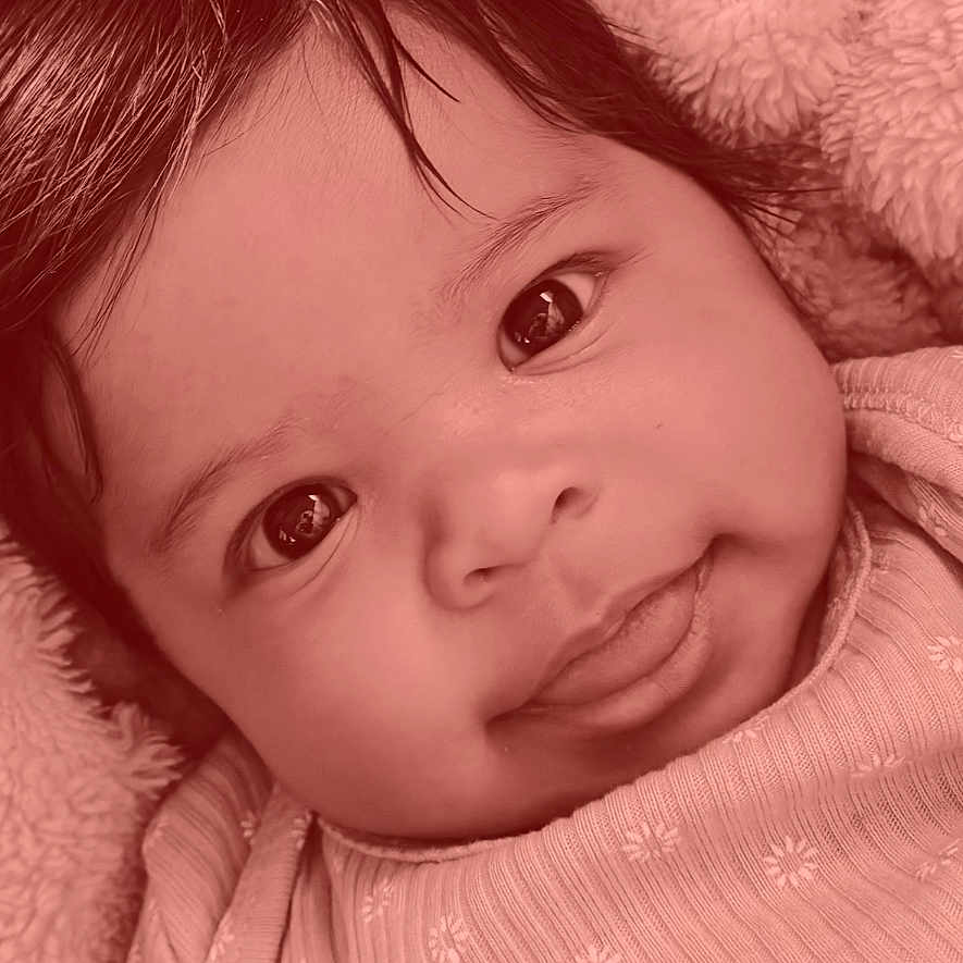 Kataliyah is registered to the contest to win money with this photo: baby, infant, face, eyes, tongue, smile, clothing, blanket, portrait, closeup, cute, child, person, indoors, cozy, lock_screen, time, date, phone_interface, happy