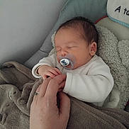 Mylo participe au concours pour gagner de l'argent avec cette photo : baby, bedtime, blanket, closeup, clothing, comfort, cozy, cushion, hand, indoor, infant, nap, pacifier, peaceful, person, resting, skin, sleeping, soft, toddler
