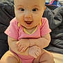 Isla is registered to the contest to win money with this photo: baby, infant, child, pink_onesie, smiling, happy, sitting, indoors, arms_crossed, legs_crossed, cute, chubby, skin, face, eyes, mouth_open, furniture, blanket, foot, hand