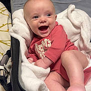 Brynlee is registered to the contest to win money with this photo: baby, infant, smiling, face, suitcase, blanket, clothing, foot, hand, indoor, happy, cute, child, newborn, person, lying_down, soft, warm, expression, cozy