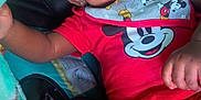 Major is registered to the contest to win money with this photo: baby, smiling, mickey_mouse, red_clothing, blanket, cartoon_characters, infant, happy, face, child, cute, playful, indoors, soft_texture, closeup, portrait, hand, seat, comfort, wrapped
