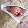 baby, infant, wrapped, towel, hooded_towel, blanket, bed, soft_texture, skin, face, hand, newborn, cute, lying_down, indoors, portrait, peaceful, comfort, resting, pink