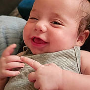 Clover joined the competition — help win amazing prizes! baby, infant, smiling, winking, pink_bow, hand_gesture, cute, indoors, cozy, portrait, closeup, child, happiness, expression, skin, clothing, person, face, head, cheerful