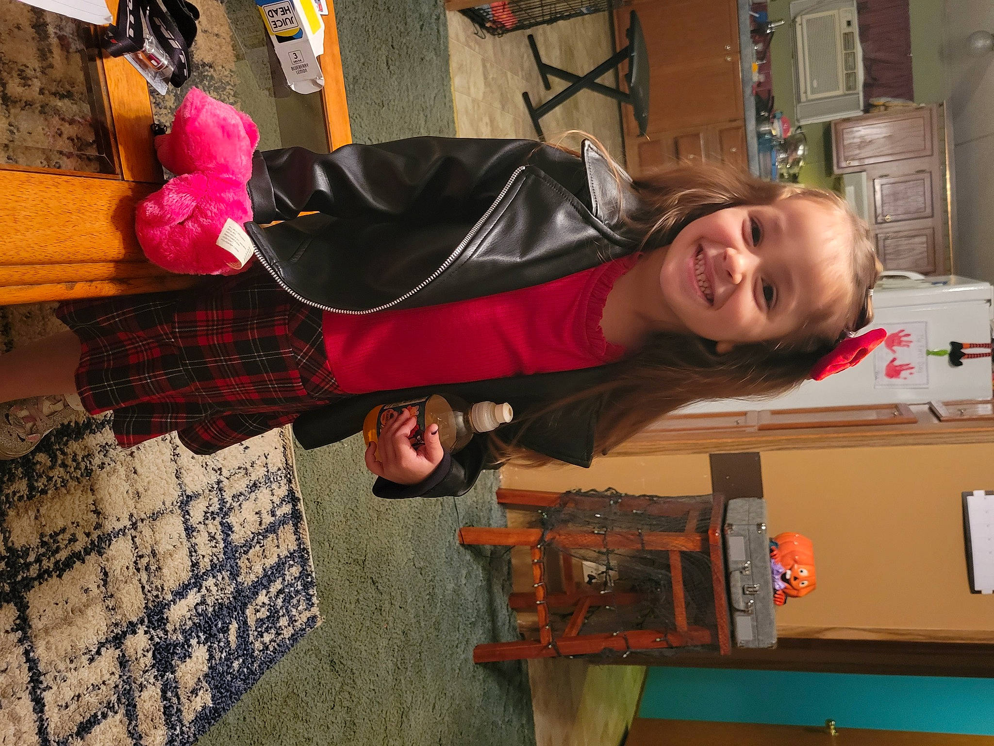 Elena is registered to the contest to win money with this photo: bag, child, flooring, fun, human_leg, jacket, joy, luggage_and_bags, machine, pattern, person, photography, plaid, room, shelf, smile, tartan, toddler, wood