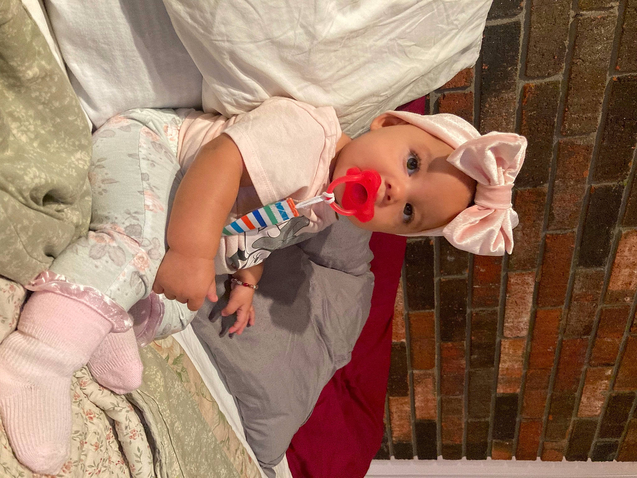 Jailysa is registered to the contest to win money with this photo: baby, baby_products, baby_toddler_clothing, brick, brickwork, child, comfort, doll, dress, happy, headwear, human_body, pattern, person, pink, sitting, skin, stuffed_toy, textile, toddler